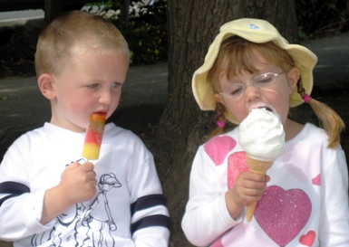 I asked my husband what he envisioned for the picture for this site and he says: "...some little pig-tailed freckle faced little girl with an ice cream cone bigger than she is ..."  Thanks to Hazel, that's what you see.  (Of  course you've also got the little tyke who thinks he got a little bit gypped.  That popsicle just isn't cuttin' it. It's written all over his face:  "I want what she's got!"  Photograph by Hazel Bregazzi of the United Kingdom.  Kids' names unknown.  Hope it's OK Mom & Dad!